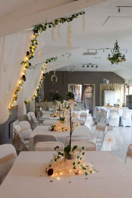 Interior view of a beautifully decorated venue for a wedding celebration at Dr Challoners in Old Amersham, arranged by flowerdeliveryamersham.co.uk. The room features round tables draped in crisp whit